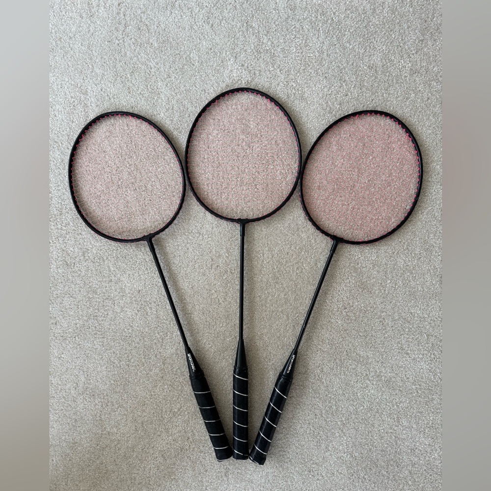 Trio of Black and Pink Badminton Rackets